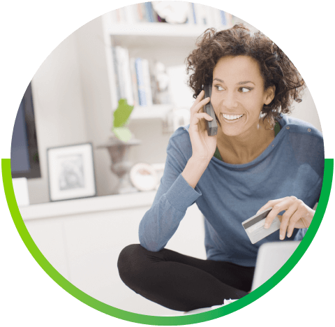 woman talking on phone holding credit card